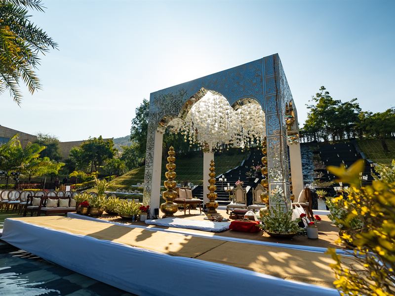 Wedding mandap decorated with mirror work by a pool